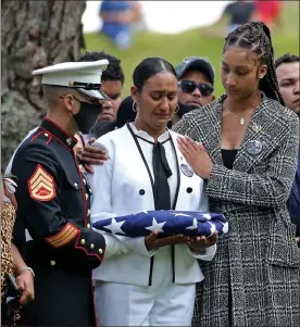  ?? Stuart caHill pHotos / boston Herald ?? Johanny rosario pichardo’s mother, colasa pichardo, receives her flag as she is comforted by her daughter rosalinda rosario at the public wake, funeral and internment for marine corps sgt. Johanny rosario pichardo, who lost her life in afghanista­n. the service was held at Veterans memorial stadium and bellevue cemetery on tuesday in lawrence.