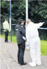  ??  ?? Gun attack Police at scene of shooting in footpath off Millgate Road, Fairhill