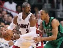  ?? EL NUEVO HERALD FILE PHOTO ?? Miami Heat guard Dwyane Wade, left, is pictured in a recent game against Boston. “I feel like I need three rings,” says Wade of the upcoming playoffs.