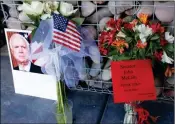  ?? ASSOCIATED PRESS PHOTOS ?? A MAKESHIFT MEMORIAL BUILDS AT THE OFFICE OF ARIZONA REPUBLICAN SEN. JOHN MCCAIN on Sunday in Phoenix. McCain, the war hero who became the GOP’s standard-bearer in the 2008 election, died at the age of 81 Saturday after battling brain cancer.