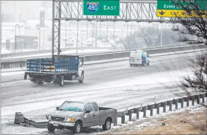  ?? Chris Machian The Associated Press ?? A pickup truck sits on the side of eastbound Interstate 480 on Monday after a crash on slick roads.