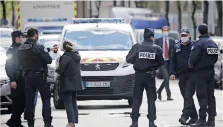  ??  ?? FRENCH police officers secure a street near the Henri Dunant Hospital where two people were shot in Paris yesterday. One person was killed, another was injured. The gunman fled on a motorcycle. | EPA
