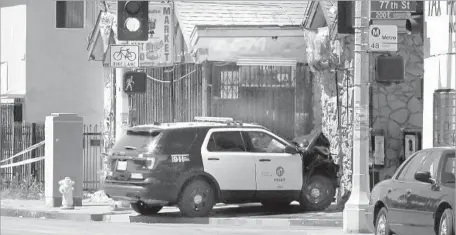  ?? Christian K. Lee Los Angeles Times ?? THE CADET SCANDAL came to light after teens in LAPD vehicles led police on a pair of wild car chases that ended in crashes in South Los Angeles the night of June 14. Here, one of the vehicles sits near 77th and San Pedro streets the day after the...