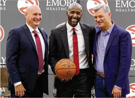  ?? CURTIS COMPTON/CCOMPTON@AJC.COM ?? Hawks general manager Travis Schlenk (left) and owner Tony Ressler (right) introduce Lloyd Pierce as the 13th full-time coach in the Atlanta history of the NBA franchise on Monday. Pierce was a Philadelph­ia 76ers assistant the past five seasons.