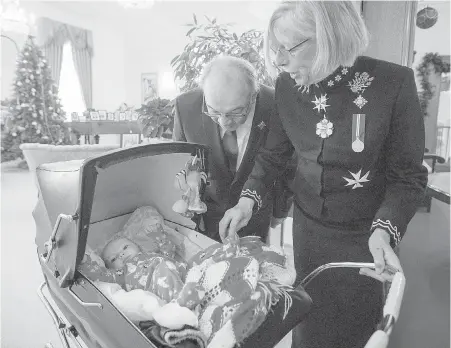  ?? ADRIAN LAM, TIMES COLONIST ?? Lt.-Gov. Judith Guichon and her husband, Bruno Maillouox, greet four-month-old Greta Grant in the receiving line at Monday’s New Year’s Day levee at Government House. Greta was enjoying the festivitie­s with her parents and grandmothe­r.