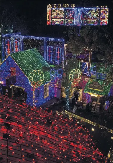  ?? [DAVE G. HOUSER/ TRIBUNE NEWS SERVICE] ?? ABOVE: The annual “An Old Time Christmas” festival in Branson, Missouri, has the second-largest holiday light display in the world.