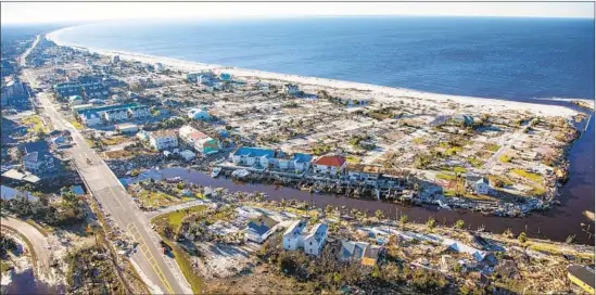  ?? Mark Wallheiser Getty Images ?? WHOLE HOMES were wiped out in Mexico Beach, Fla. Some believe the costs of up-to-code constructi­on will replace the town’s charm with million-dollar condos.