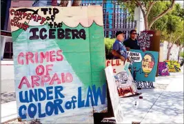  ?? ASSOCIATED PRESS ?? IN THIS JULY 6 FILE PHOTO, PHOENIX RESIDENTS Raul Cordero and Franklyn Olivieri stand in front of the federal courthouse in Phoenix. An audit report produced in a racial profiling case against the Maricopa County Sheriff’s Office says Hispanics are...