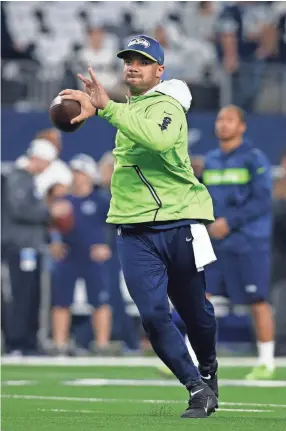  ??  ?? Seahawks quarterbac­k Russell Wilson, seen before a playoff game Jan. 5, agreed to a $140 million, four-year extension with Seattle. TIM HEITMAN/USA TODAY SPORTS