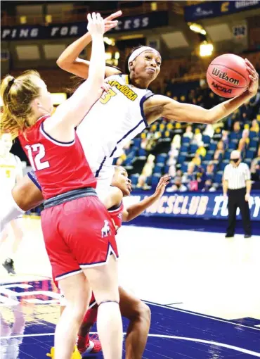  ?? STAFF PHOTOS BY ROBIN RUDD ?? UTC’s Eboni Williams pulls in an offensive rebound between a pair of Samford players during Saturday’s SoCon game at McKenzie Arena. Williams grabbed 14 rebounds as the Mocs won 70-57 two days after losing by 11 to the same team.