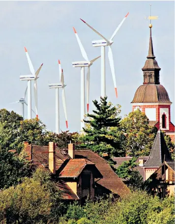  ??  ?? ‘Green energy’, including these windmills in Brandenbur­g, are predicted to have cost Germany £470 billion by 2025