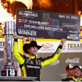 ?? Jared C. Tilton, Getty Images ?? Ryan Blaney celebrates with the million dollar check after winning Sunday in Fort Worth, Texas.