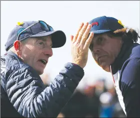  ?? AP/FRANCOIS MORI ?? United States Ryder Cup team captain Jim Furyk (left) gestures while speaking with Phil Mickelson during Saturday’s matches at the Ryder Cup in France. Mickelson was benched for both the four-ball and foursome matches. Four years ago, Mickelson was benched by captain Tom Watson, and he later criticized Watson. This time, Mickelson was understand­ing of Furyk’s decision to sit him out.