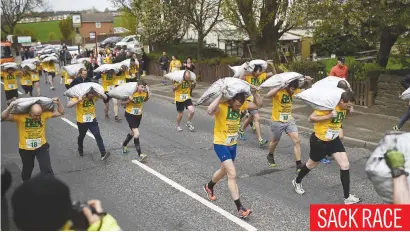  ?? Picture: AFP ?? Competitor­s take part in the men’s race at the annual World Coal Carrying Championsh­ips in the village of Gawthorpe, near Dewsbury, northern England, yesterday.