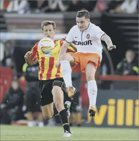  ?? Picture: Robert Perry ?? dundee united’s Paul Paton, right, clears the danger last night as James Craigen of Partick thistle closes in