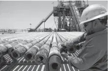  ??  ?? A man working at Rumaila oilfield in Basra, Iraq, 2017.