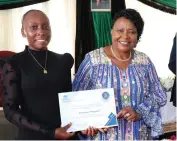  ?? ?? Patron of Tourism and Hospitalit­y First Lady Dr Auxillia Mnangagwa hands over a scholarshi­p from United Nations Tourism to Charmaine Mugwagwa at Zimbabwe House yesterday