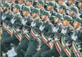  ?? AGENCIES ?? IRGC members (top) at a parade in Tehran; an anti-US banner (left) at a rally in Peshawar, Pakistan.