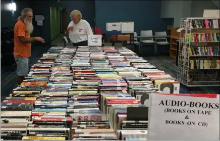  ?? RICHARD PAYERCHIN — THE MORNING JOURNAL ?? Friends of the Lorain Public Library Inc. volunteers Jay Metzger, left, and Pat Rohner, both from Lorain, sort books to prepare for the latest Friends’ book sale. It will run Sept. 17to 23at the Main Library, 351W. Sixth St.