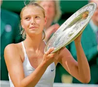  ?? — AFP file ?? Maria Sharapova of Russia holds the trophy after defeating Serena Williams of the US 6-1, 6-4 in the final of the 2004 Wimbledon Tennis Championsh­ips.