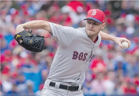  ?? — THE CANADIAN PRESS ?? Red Sox starting pitcher Chris Sale was dynamite against the Toronto Blue Jays on Canada Day, striking out 11 batters while throwing a season-high 116 pitches in a 7-1 Boston victory in front of 46,672 at Rogers Centre in Toronto on Saturday.