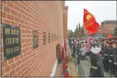  ?? (AP/Alexander Zemlianich­enko) ?? People queue to lay flowers at the grave of Gagarin in 2019. After Gagarin died in a training jet crash in March 1968, he was buried near the Kremlin Wall alongside Soviet leaders.