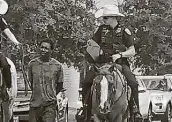  ?? Associated Press file photo ?? Donald Neely, center, is handcuffed and led on a rope by two Galveston police officers in 2019.