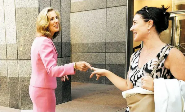  ?? Matt Freed/Post-Gazette photos ?? U.S. Senate candidate Katie McGinty talks with friend Kathryn Stack Wednesday outside her campaign office in Philadelph­ia.