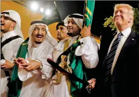  ?? REUTERS ?? Saudi Arabia’s King Salman welcomes US President Donald Trump to dance with a sword during a welcome ceremony at Al Murabba Palace in Riyadh, Saudi Arabia on 20 May.