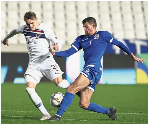  ?? — AP ?? Eyes on theball: Norway’s Martin Odegaard (left) vying for the ball with Cyprus’ Nicholas Ioannou during the Nations League match at the GSP Stadium in Nicosia, Cyprus, on Monday.