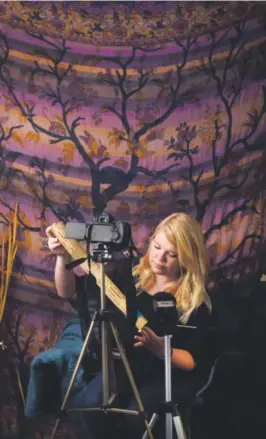  ??  ?? Ashlie Holbrook, known on YouTube as WhispersUn­icorn, uses a rain stick – which features soothing sounds – for a video. AAron Ontiveroz, The Denver Post