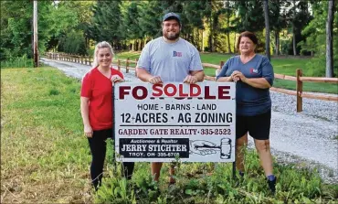  ?? CONTRIBUTE­D PHOTOS ?? Bailey Martin (left), Wes Martin and Rhonda Martin, Wes’ mom, celebrate the purchase of an old winery on 121/2 acres outside West Milton that will be home to Brave Breed Rescue.