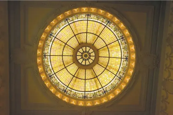  ?? AMY DAVIS/BALTIMORE SUN ?? The stained-glass dome skylight above the main banking lobby is attributed to Baltimore artist Gustave Baumstark, who studied with Louis C. Tiffany and John La Farge.