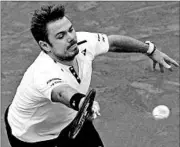  ?? CHRISTOPHE ENA/AP ?? Defending champion Stan Wawrinka lunges for a return during Monday’s second day at the French Open in Paris.