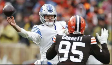  ?? RON SCHWANE — THE ASSOCIATED PRESS ?? Detroit Lions quarterbac­k Tim Boyle throws under pressure from Cleveland Browns defensive end Myles Garrett during Sunday’s loss to the Cleveland Browns. Boyle struggled in his first start, passing for just 77yards and two intercepti­ons.
