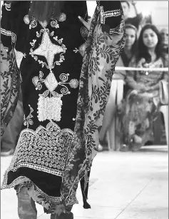 ??  ?? A Syrian-Kurdish woman models traditiona­l Kurdish attire during a fashion show in the northeaste­rn Syrian city of Qamishli earlier this month.