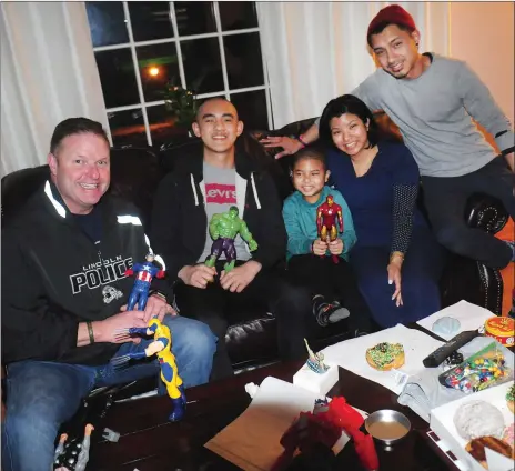  ?? Photo by Ernest A. Brown ?? Lincoln 6-year-old Austin Chea, center, who is battling leukemia, enjoys a visit from Lincoln Police Captain Phil Gould, leftl and Lincoln High junior David Du,second from left. Chea’s parents, Vannay Peov, second from right, and David Chea, right, are...