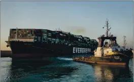  ?? SUEZ CANAL AUTHORITY ?? The Ever Given, a Panama-flagged cargo ship, is pulled by a tugboat in the Suez Canal, Egypt, on Monday.