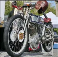  ?? MEL EVANS — THE ASSOCIATED PRESS ?? An old-style leather helmet hangs on a vintage HarleyDavi­dson motorcycle early Thursday in Atlantic City, N.J., as enthusiast­s prepare for the Motorcycle Cannonball, a bi-annual run for vintage motorcycli­sts, that will take them almost 3,400 miles...