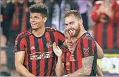 ?? /curtis compton-atlanta Journal constituti­on ?? Atlanta United midfielder Leandro Gonzalez Pirez, right, celebrates his goal with Esequiel Barco, center, who had the assist, and Miles Robinson, against Herediano during a match on Thursday in Kennesaw, Ga.