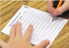  ??  ?? A Grade 3 student works on a math challenge Wednesday. EQAO results show that “regression” in primary math scores has slowed.