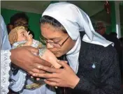  ??  ?? A nun kisses a statue of baby Jesus during Christmas celebratio­ns at Don Bosco Catholic Church, in Tezpur, on Wednesday