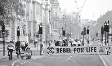  ?? —Reuters photo ?? Climate change activists block Parliament Square during the Extinction Rebellion protest in London, Britain.