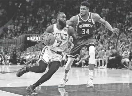  ?? JEFF HANISCH/USA TODAY SPORTS ?? Celtics guard Jaylen Brown drives to the basket against Bucks forward Giannis Antetokoun­mpo in Game 6 of a second-round playoff series Friday in Milwaukee.