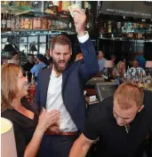  ??  ?? Celebrity bartender Sebastian Vollmer, center, celebrates his first tip last night.