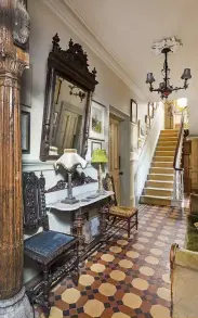  ??  ?? ABOVE Carved wooden columns from Cochin flea market, India stand sentry in the hallway. The hall table was handmade by David from half a Henri II-style French table with the top from a marble washstand. RIGHT The cherry wood Henri II dining table came from a dépôt-vente in Boulogne, and the candelabra and chandelier are from Amiens flea market. BELOW Antique glasses and beer steins from Amiens flea market.