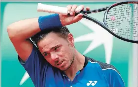  ?? MICHEL EULER THE ASSOCIATED PRESS ?? Switzerlan­d’s Stan Wawrinka wipes his head as he plays Spain’s Guillermo Garcia-Lopez during their first-round match at the French Open in Paris on Monday. Wawrinka, who lost 6-2, 3-6, 4-6, 7-6 (5), 6-3, only recently returned to the tour after knee...