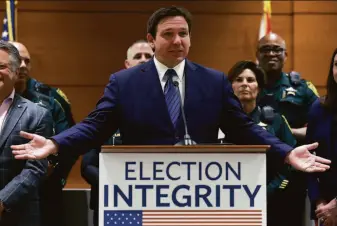 ?? Joe Raedle / Getty Images ?? Florida Gov. Ron DeSantis discusses charges brought against 17 people for illegal voting during a news conference held Thursday at the Broward County Courthouse in Fort Lauderdale.