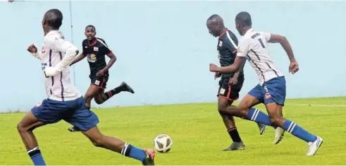  ?? Picture: MICHAEL PINYANA ?? IN PURSUIT: Seven Stars FC from Komani, in white, playing against Relatives FC from Mdantsane at Sisa Dukashe Stadium.