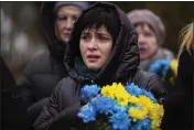  ?? EMILIO MORENATTI — THE ASSOCIATED PRESS ?? A woman cries during a memorial service in a cemetery in Bucha, Ukraine, on Friday to mark the one-year anniversar­y of the start of the Russia Ukraine war.